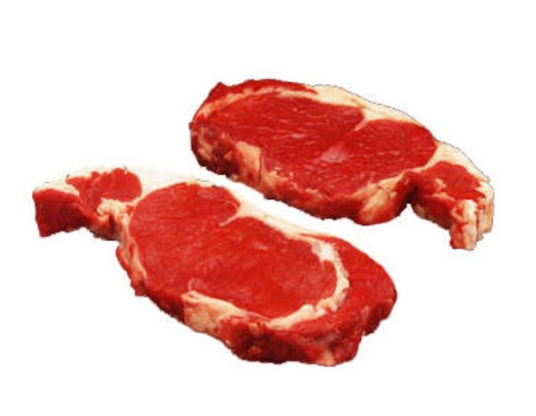 2 raw bison ribeye steaks on white background