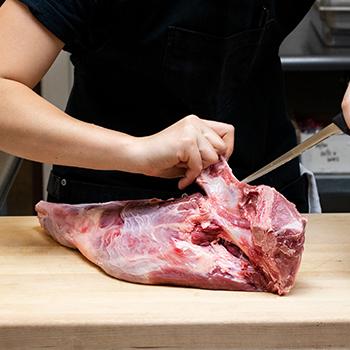 Boar leg being butchered