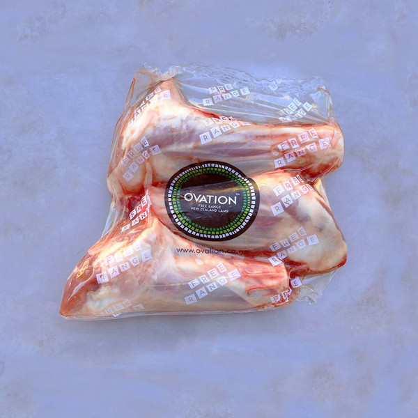 3 raw grass-fed Ovation lamb hindshanks in a labelled package on a marble background