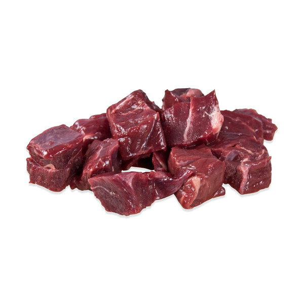 Raw pieces of elk stew meat mounded on white background