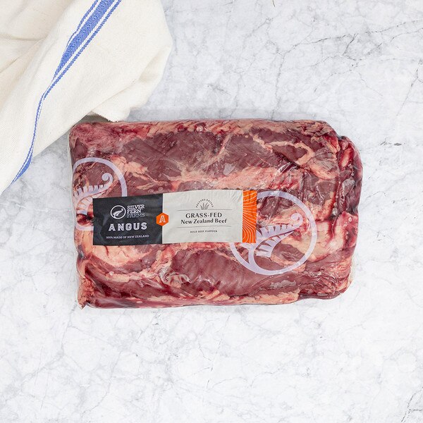 One vacuum-sealed package of Silver Fern Farms grass-fed New Zealand Angus beef hanging tenders on a marble background with blue-striped kitchen towel.