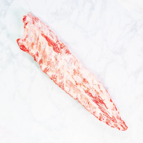 Whole raw rack of Iberico pork baby back ribs on marble background