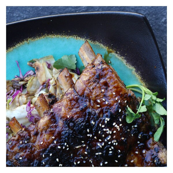 Cooked kalbi glazed Iberico pork spare ribs & cabbage on a blue & black square plate