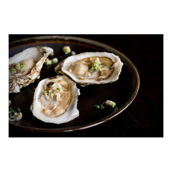 Round plate with 3 raw Shigoku oysters on the half shell sprinkled with grated wasabi & minced herbs
