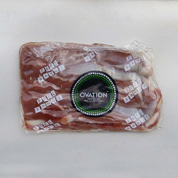 Labelled package of raw grass-fed free range Ovation lamb tenderloin on gray background