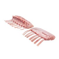 Two raw petite veal racks with 8 bones each on a white background