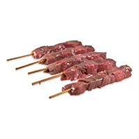 5 skewers of raw venison chunks on white background