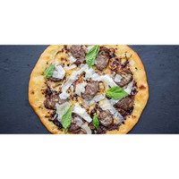 Pizza with wild boar sausage, cheese, basil leaves, dark gray background