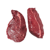 2 raw bison hanging tender steaks on white background