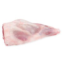 Raw bone-in grass-fed lamb leg on white background