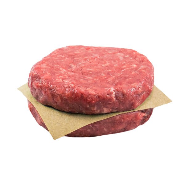 Two raw, grain-fortified beef burger patties stacked with a square of brown parchment paper between them.