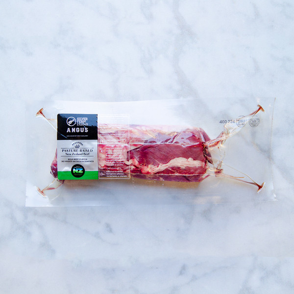 Raw New Zealand grass-fed Angus beef hanger steak in a vacuum sealed pack on a white marble slab