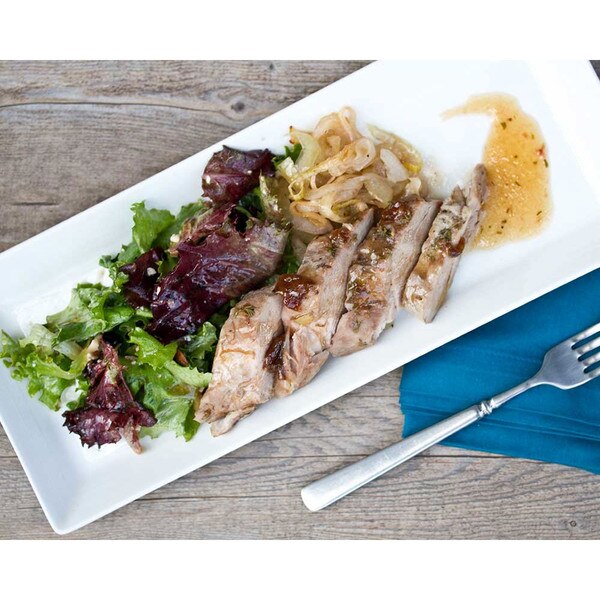 Cooked, sliced Kurobuta pork tenderloin, lettuce, grilled onions, plum sauce, rectangular white plate, blue napkin, fork