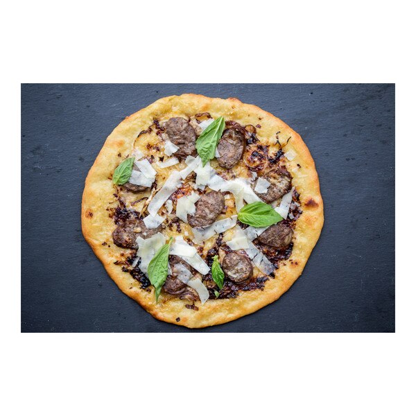 Pizza topped with Wild Boar sausage, basil leaves & shaved cheese